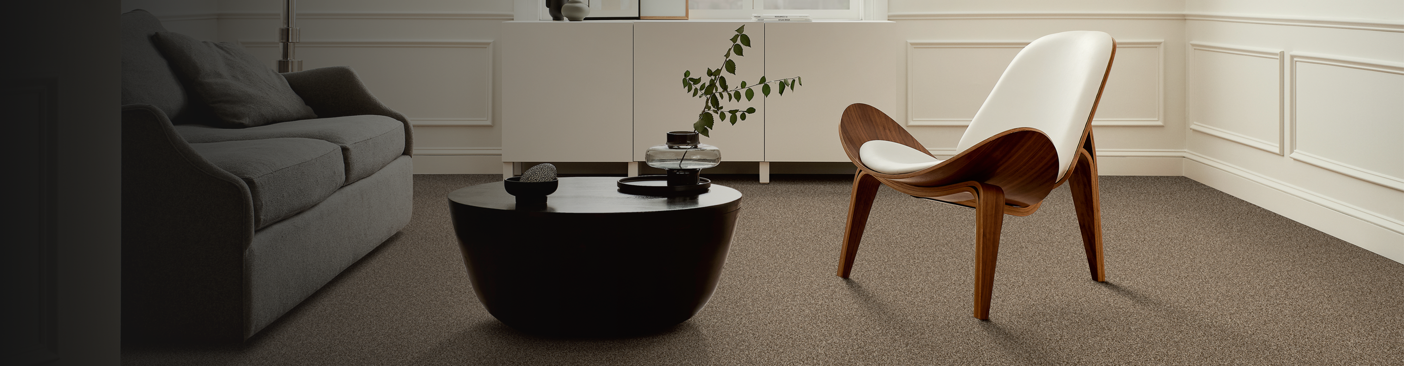 Brown carpet in a sitting area with a wooden chair