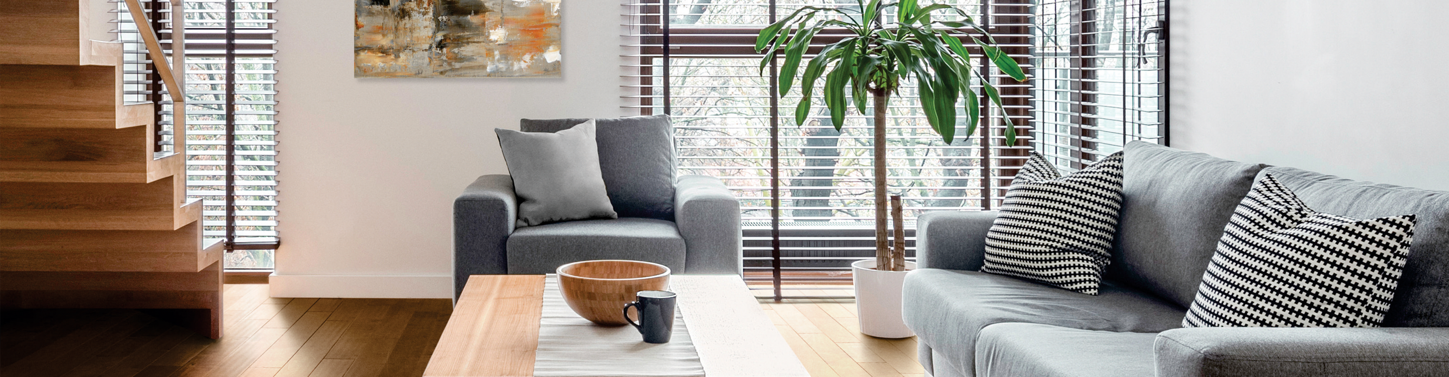 brown wood-look blinds in living room with light hardwood floors and gray furniture